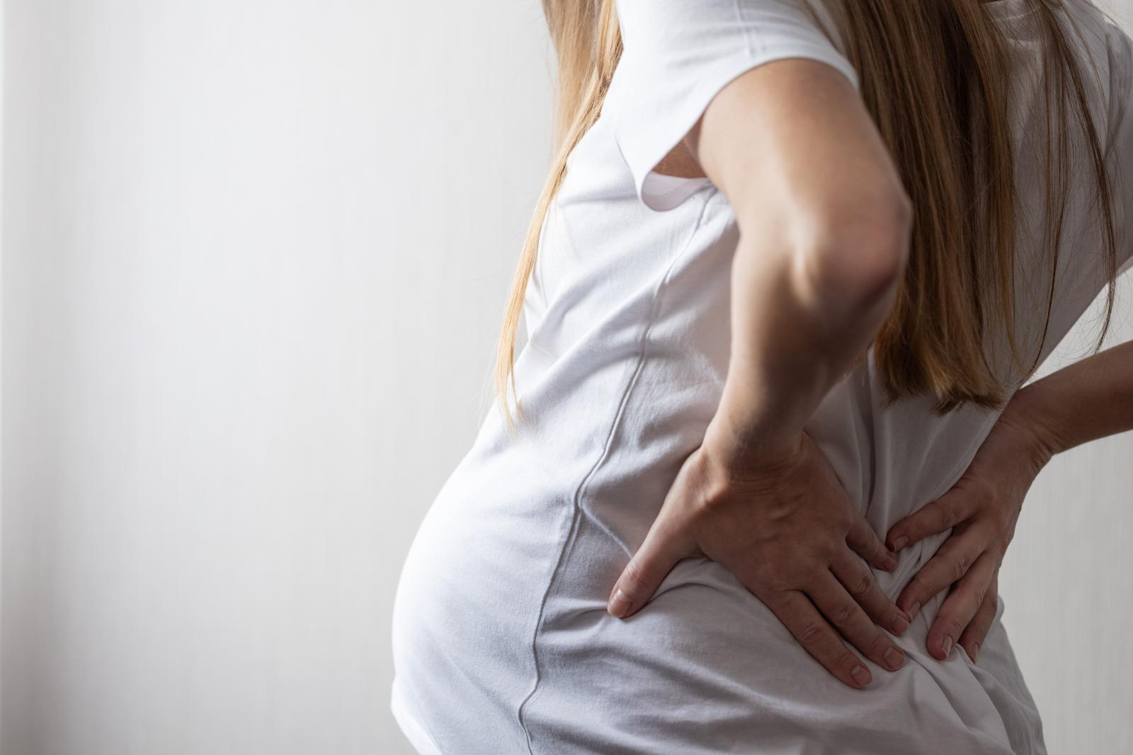 pain.jpgWoman holding her lower back in pain, a common complaint treated through osteopathy.